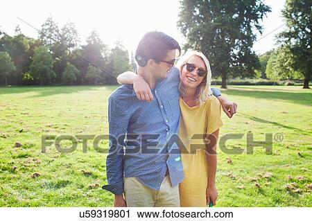 Portrait of romantic young couple in sunlit park View Large Photo Image Stock Image - Portrait of romantic young couple in sunlit park. Fotosearch