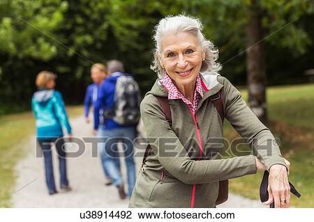 Portrait of senior woman on pathway in forest View Large Photo Image Stock Image - Portrait of senior woman on pathway in forest. Fotosearch