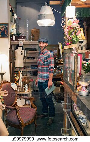 Stock Photo - Portrait of stylish mid adult man in vintage shop. Fotosearch