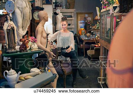 Portrait of stylish young woman sitting in vintage shop View Large Photo Image Stock Photography - Portrait of stylish young woman sitting in vintage shop. Fotosearch