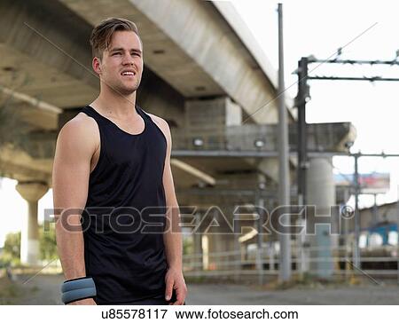 Portrait of young man in sports clothing in urban environment View Large Photo Image Stock Photo - Portrait of young man in sports clothing in urban environment. Fotosearch