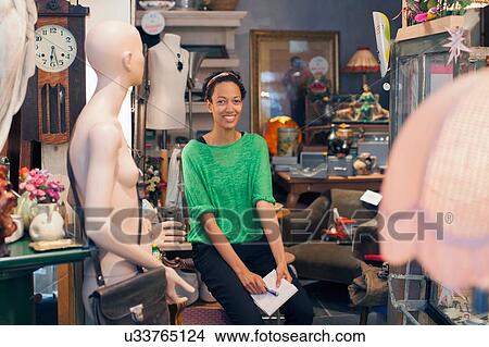 Picture - Portrait of young woman in vintage shop. Fotosearch