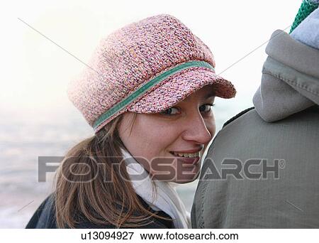 Portrait of young woman looking over boyfriends shoulder at coast View Large Photo Image Stock Photo - Portrait of young woman looking over boyfriends shoulder at coast. Fotosearch