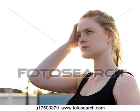 Stock Photo - Portrait of young woman training in parking lot. Fotosearch