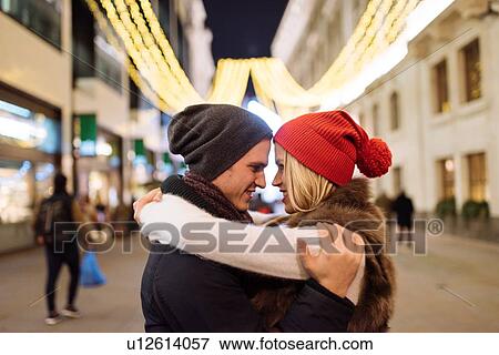 Romantic young couple hugging on street at xmas, London, UK View Large Photo Image Stock Photo - Romantic young couple hugging on street at xmas, London, UK. Fotosearch