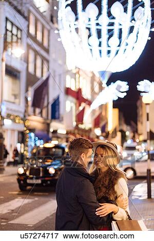 Romantic young couple on New Bond street at xmas, London, UK View Large Photo Image Stock Photo - Romantic young couple on New Bond street at xmas, London, UK. Fotosearch