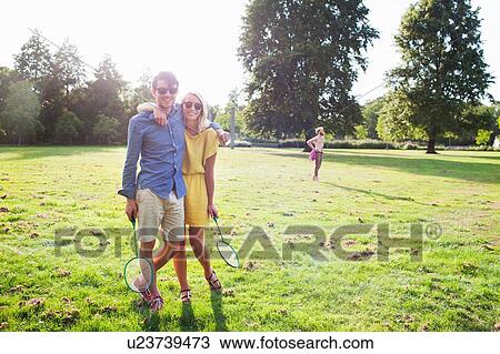 Romantic young couple with badminton rackets in sunlit park View Large Photo Image Stock Image - Romantic young couple with badminton rackets in sunlit park. Fotosearch