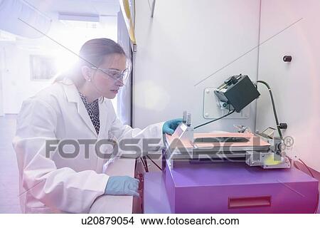 Scientist making lithium ion battery samples in battery research facility View Large Photo Image Picture - Scientist making lithium ion battery samples in battery research facility. Fotosearch