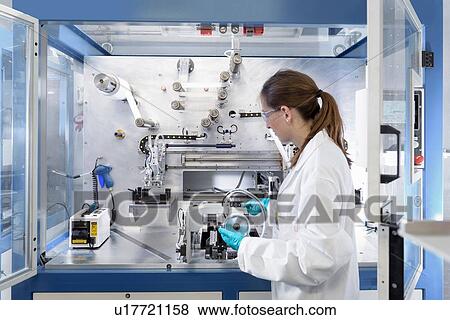 Scientist making lithium ion battery samples in battery research facility View Large Photo Image Stock Photo - Scientist making lithium ion battery samples in battery research facility. Fotosearch