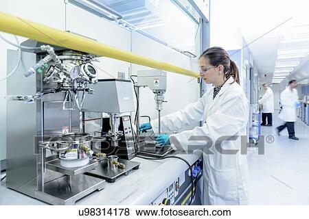 Scientist making lithium ion battery samples in battery research facility View Large Photo Image Stock Photo - Scientist making lithium ion battery samples in battery research facility. Fotosearch