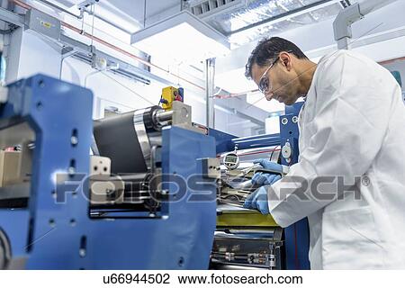 Scientist manufacturing lithium ion batteries in battery research facility View Large Photo Image Stock Image - Scientist manufacturing lithium ion batteries in battery research facility. Fotosearch