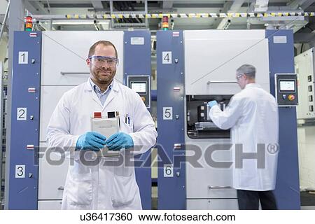 Scientist with lithium ion pouch cell manufacture machine in battery research facility, portrait View Large Photo Image Stock Image - Scientist with lithium ion pouch cell manufacture machine in battery research facility, portrait. Fotosearch