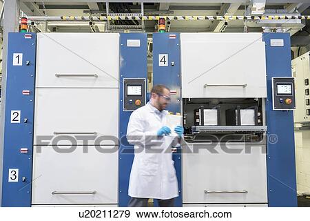 Scientist with lithium ion pouch cell manufacture machine in battery research facility View Large Photo Image Stock Photo - Scientist with lithium ion pouch cell manufacture machine in battery research facility. Fotosearch