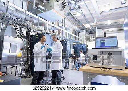 Stock Photo - Scientists in lithium ion battery testing facility in battery research facility. Fotosearch