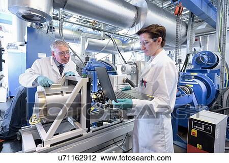 Scientists testing lithium car battery with electric motor car in battery research facility View Large Photo Image Stock Image - Scientists testing lithium car battery with electric motor car in battery research facility. Fotosearch