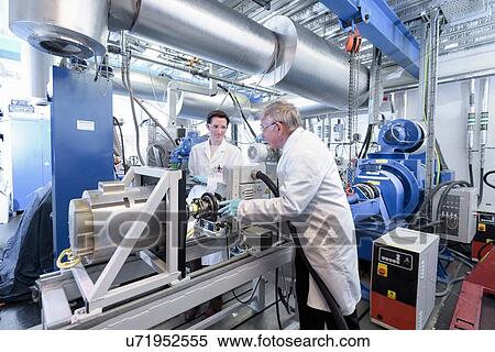 Scientists testing lithium car battery with electric motor car in battery research facility View Large Photo Image Stock Photography - Scientists testing lithium car battery with electric motor car in battery research facility. Fotosearch