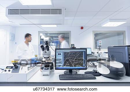 Scientists use microscope to look at lithium ion battery surface in battery research facility View Large Photo Image Stock Photo - Scientists use microscope to look at lithium ion battery surface in battery research facility. Fotosearch