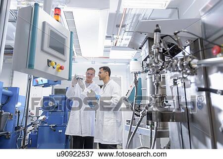 Scientists with lithium ion battery production line in battery research facility View Large Photo Image Stock Photo - Scientists with lithium ion battery production line in battery research facility. Fotosearch