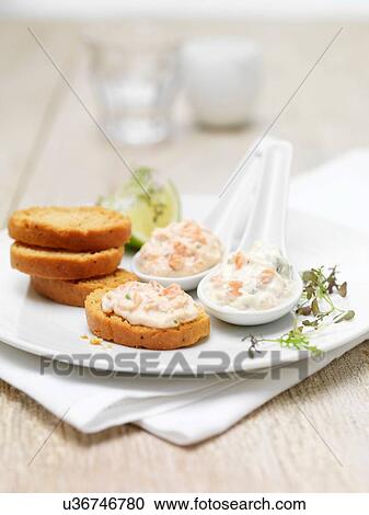 Stock Image - Scottish lochmuir salmon pate and tartare dipping platter with toasted bread crackers. Fotosearch
