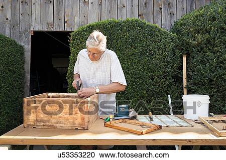 Senior man making wooden crate in garden View Large Photo Image Stock Image - Senior man making wooden crate in garden. Fotosearch