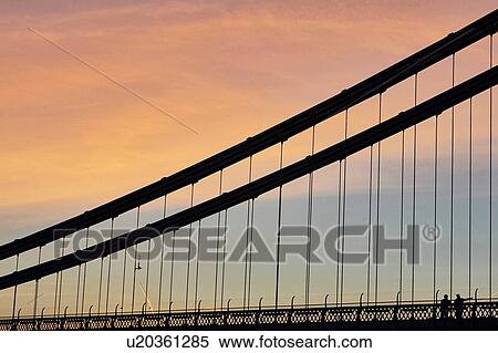 Stock Photography - Silhouetted detail of Clifton suspension bridge at sunset, Bristol, UK. Fotosearch