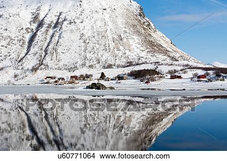 Snow covered mountain reflected in water, Knutstad, Lofoten Islands, Norway View Large Photo Image Picture - Snow covered mountain reflected in water, Knutstad, Lofoten Islands, Norway. Fotosearch