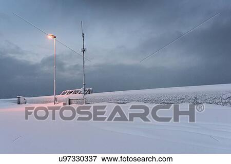 Stock Photo - Snow covered wall illuminated by lamppost, Reykjavik, Iceland. Fotosearch