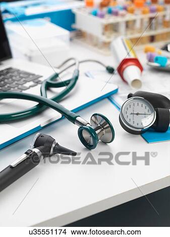Picture - Stethoscope, auriscope, blood pressure gauge on desk. Fotosearch