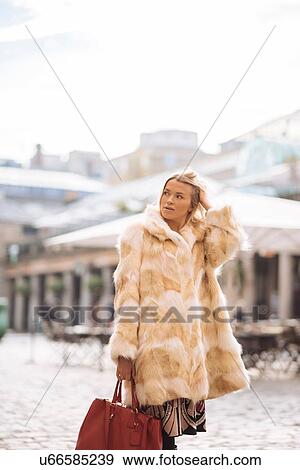 Stylish young woman standing in Covent Garden, London, UK View Large Photo Image Stock Photo - Stylish young woman standing in Covent Garden, London, UK. Fotosearch