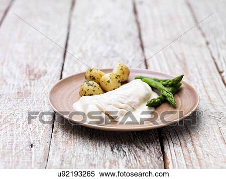 Two haddock fillets with a mornay sauce, served with asparagus and new potatoes View Large Photo Image Stock Photography - Two haddock fillets with a mornay sauce, served with asparagus and new potatoes. Fotosearch