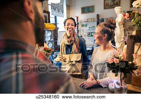 Two happy young female customers buying from vintage shop View Large Photo Image Stock Image - Two happy young female customers buying from vintage shop. Fotosearch
