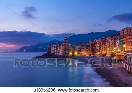 Stock Photograph - View of beach and hotels at dusk, Camogli, Liguria, Italy. Fotosearch