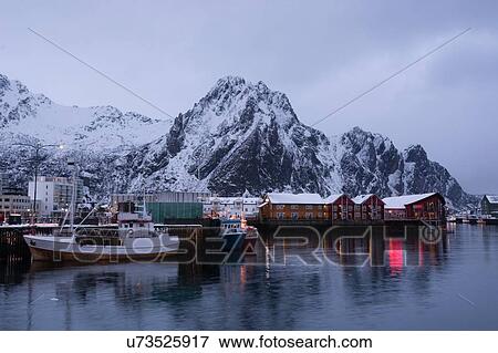 Stock Photo - Waterfront harbor and fishing boats at dusk, Svolvaer, Lofoten Islands, Norway. Fotosearch