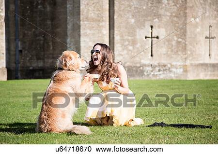 Woman posing with cup of tea and golden retriever dog at Thornbury Castle, South Gloucestershire, UK View Large Photo Image Stock Image - Woman posing with cup of tea and golden retriever dog at Thornbury Castle, South Gloucestershire, UK. Fotosearch