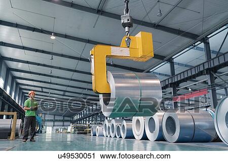 Stock Image - Worker in solar panel assembly factory, Solar Valley, Dezhou, China. Fotosearch