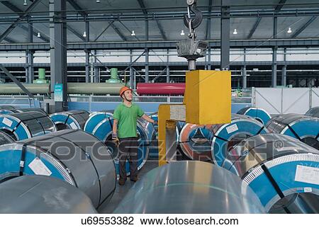 Stock Image - Worker in solar panel assembly factory, Solar Valley, Dezhou, China. Fotosearch