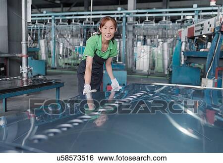 Stock Photograph - Worker in solar panel assembly factory, Solar Valley, Dezhou, China. Fotosearch