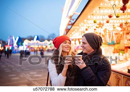 Young couple drinking mulled wine at Xmas festival, Hyde Park, London, UK View Large Photo Image Stock Photo - Young couple drinking mulled wine at Xmas festival, Hyde Park, London, UK. Fotosearch