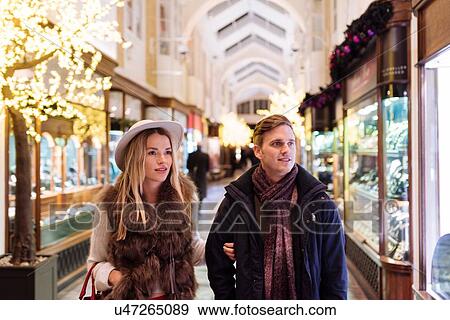Stock Photo - Young couple shopping in Burlington Arcade at xmas, London, UK. Fotosearch
