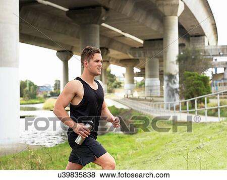 Stock Photo - Young man running, outdoors. Fotosearch