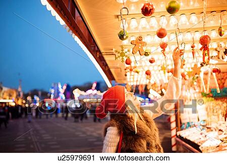 Young woman choosing baubles at xmas festival in Hyde Park, London, UK View Large Photo Image Stock Image - Young woman choosing baubles at xmas festival in Hyde Park, London, UK. Fotosearch