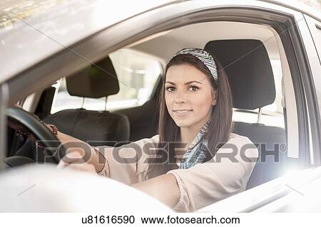 Young woman driving car, smiling View Large Photo Image Stock Image - Young woman driving car, smiling. Fotosearch