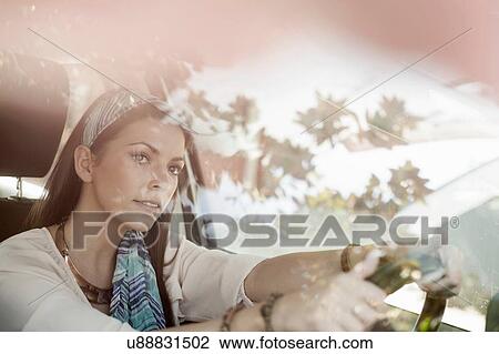 Young woman driving, looking through windscreen View Large Photo Image Stock Image - Young woman driving, looking through windscreen. Fotosearch