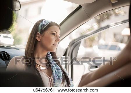 Young woman, sitting, relaxing in car View Large Photo Image Stock Image - Young woman, sitting, relaxing in car. Fotosearch