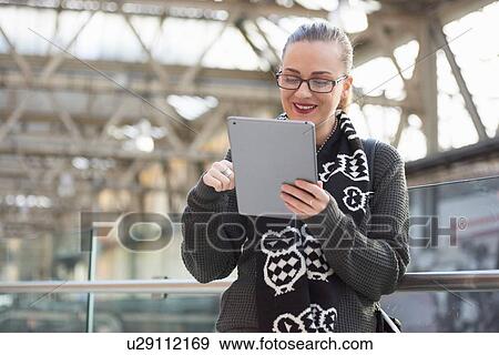 Young woman using digital tablet, smiling View Large Photo Image Stock Photo - Young woman using digital tablet, smiling. Fotosearch
