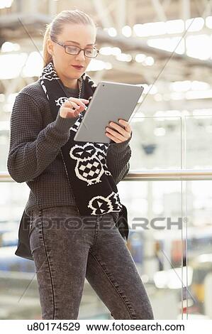 Young woman, using digital tablet, outdoors View Large Photo Image Stock Photo - Young woman, using digital tablet, outdoors. Fotosearch