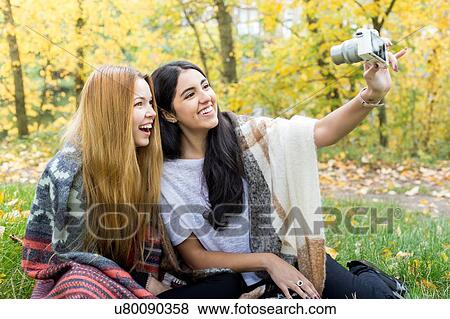 Young women taking selfie in forest, Hampstead Heath, London View Large Photo Image Stock Photo - Young women taking selfie in forest, Hampstead Heath, London. Fotosearch
