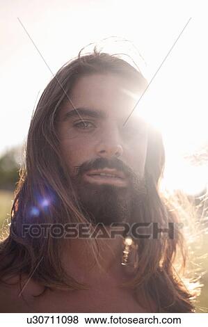 Bearded young man with long hair View Large Photo Image Stock Photo - Bearded young man with long hair. Fotosearch