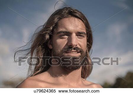Stock Photography - Bearded young man with long hair. Fotosearch