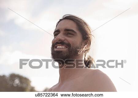 Bearded young man with ponytail View Large Photo Image Picture - Bearded young man with ponytail. Fotosearch